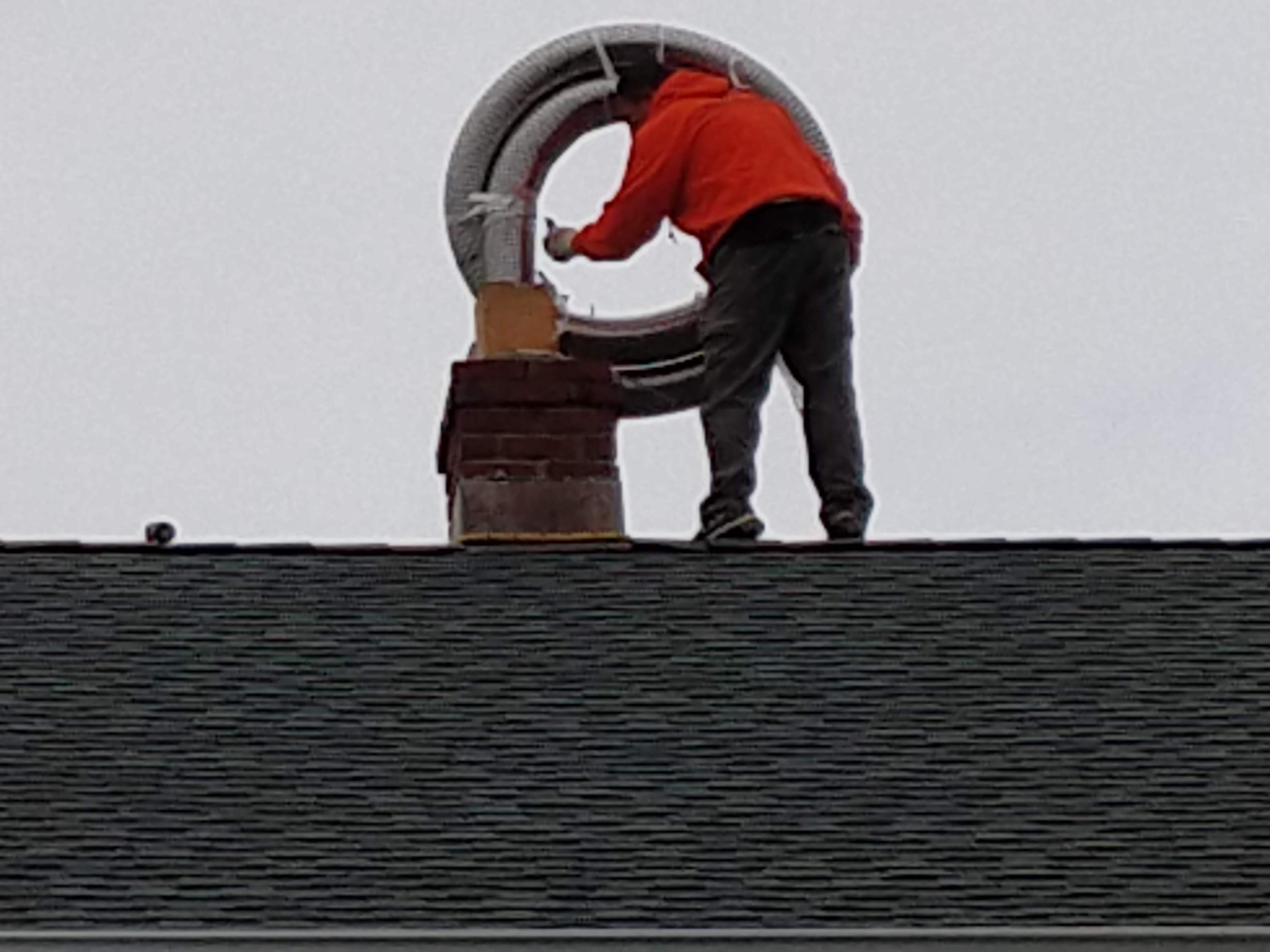 Flexible stainless chimney liner being installed in Port Washington, New York
